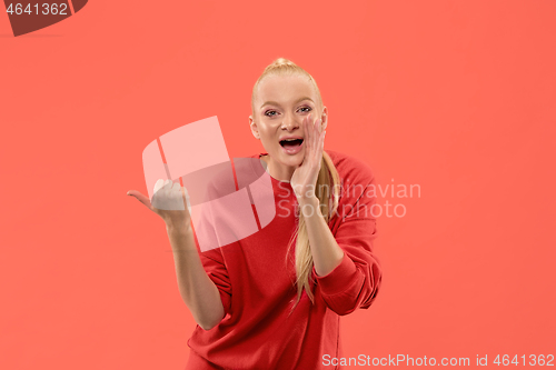 Image of Isolated on coral young casual woman shouting at studio