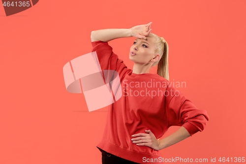 Image of Beautiful woman looking suprised and bewildered isolated on coral