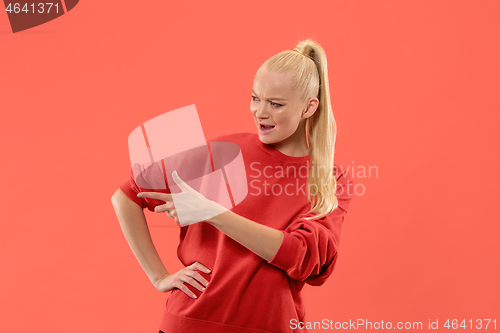 Image of Isolated on coral young casual woman shouting at studio