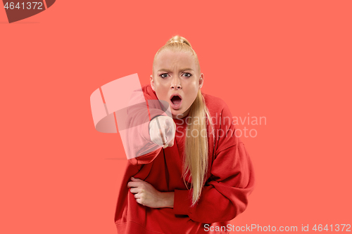 Image of The overbearing business woman point you and want you, half length closeup portrait on coral background.