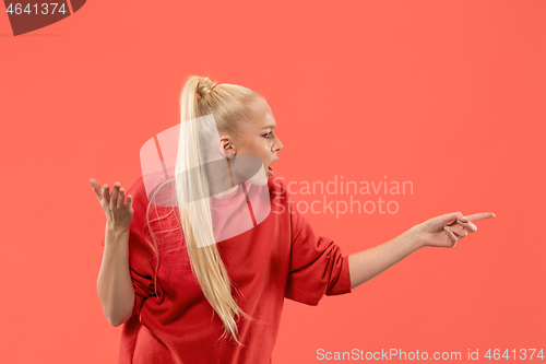 Image of Beautiful woman looking suprised isolated on coral