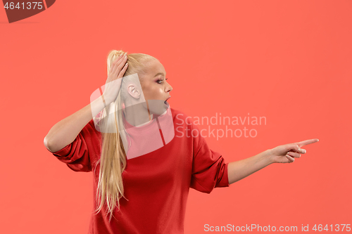 Image of Beautiful woman looking suprised isolated on coral