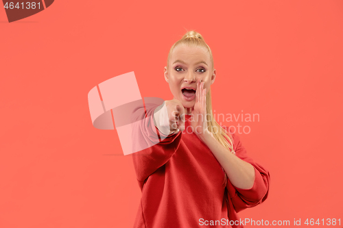 Image of The overbearing business woman point you and want you, half length closeup portrait on coral background.