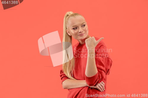 Image of Beautiful woman looking suprised isolated on coral