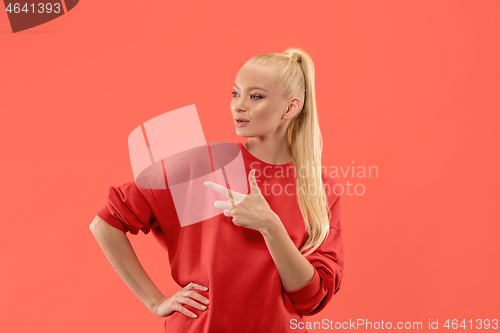 Image of Isolated on coral young casual woman shouting at studio