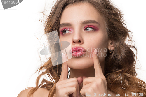 Image of Nice young woman with long wavy silky hair, natural make up looking at camera