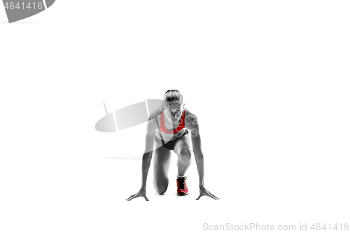 Image of Portrait of young sporty woman at starting block of race isolated over white background