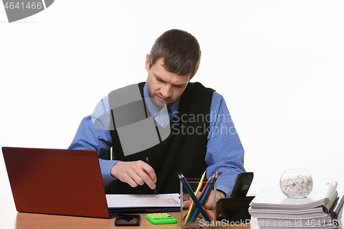 Image of disgruntled manager checks graphs in documents on a white background