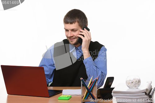 Image of Office worker talks on the phone with customers