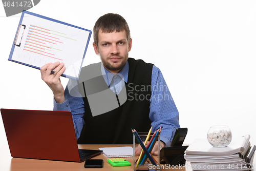 Image of Office worker shows crossed out schedule sitting in the workplace