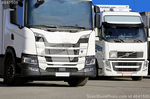 Image of Two White Freight Trucks