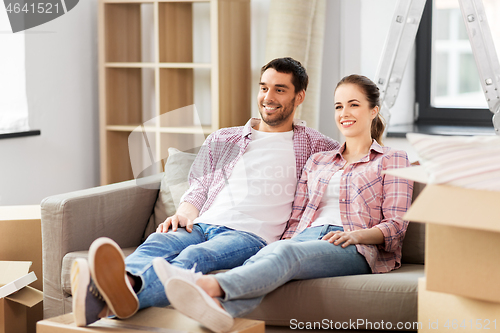 Image of happy couple with boxes moving to new home