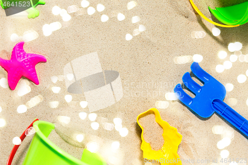 Image of close up of sand toys kit on summer beach