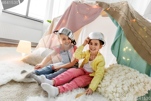 Image of girls with pots playing in kids tent at home