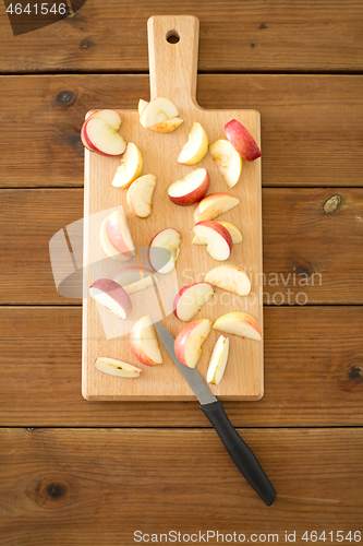 Image of sliced apples and knife on wooden cutting board