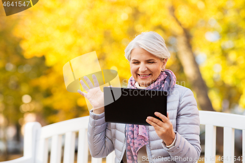 Image of senior woman with tablet pc at summer park