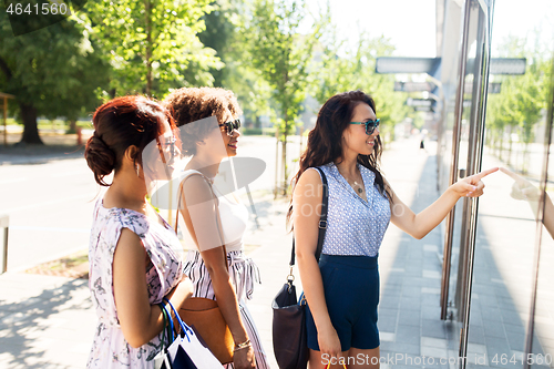 Image of women with shopping bags looking at shop window