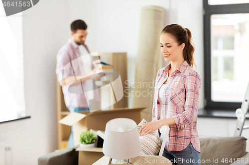 Image of happy couple with stuff moving to new home