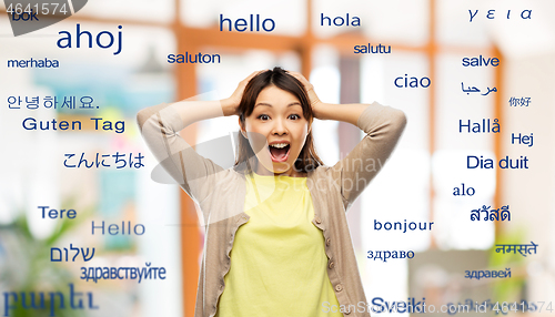 Image of happy asian woman over foreign words