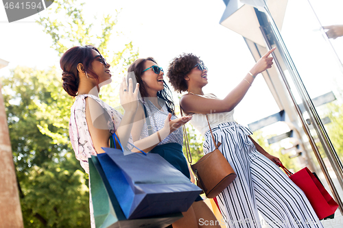 Image of women with shopping bags looking at shop window