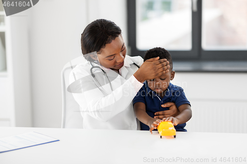 Image of doctor with measuring baby\'s temperature at clinic