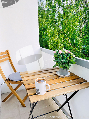 Image of cup of coffee on balcony table