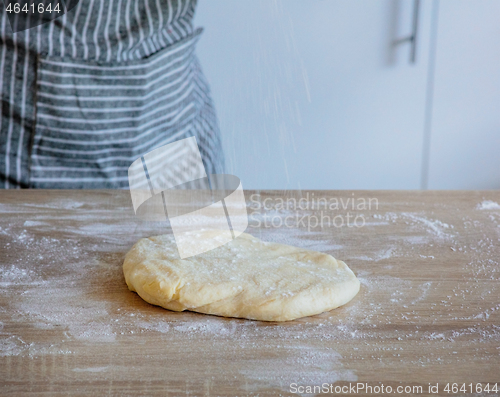 Image of flour falls on the dough