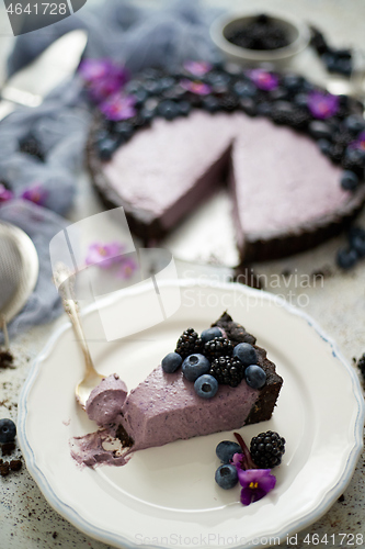 Image of Plate with homemade piece of delicious blueberry, blackberry and grape pie or tart served on table