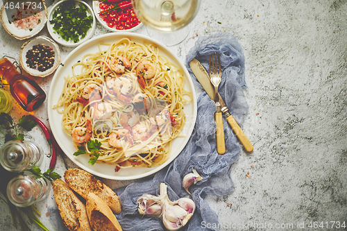 Image of Seafood concept. Pasta with shrimps in a plate, close-up, copy space, top view, flat lay.