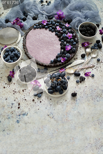 Image of Sweet and tasty tart with fresh blueberries, blackberries and gr