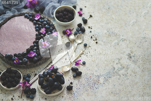 Image of Sweet and tasty tart with fresh blueberries, blackberries and gr