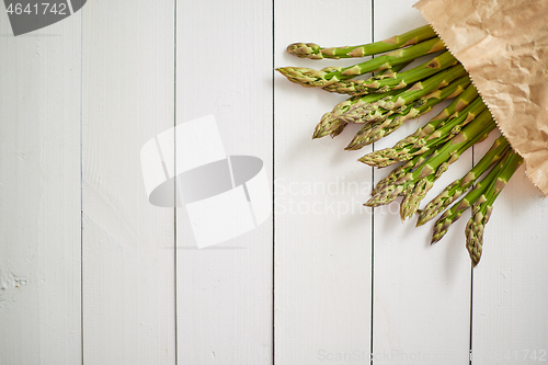 Image of Fresh green asparagus in a brown paper bag. Healthy eating concept. Food for vegetarians