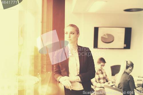 Image of portrait of young business woman at office with team on meeting 