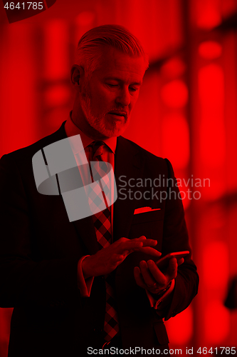 Image of senior business man talk on mobile phone