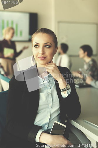 Image of portrait of young business woman at office with team on meeting 