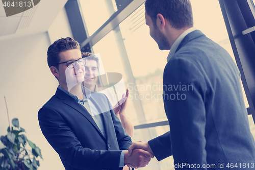 Image of cloasing the deal in modern office interior