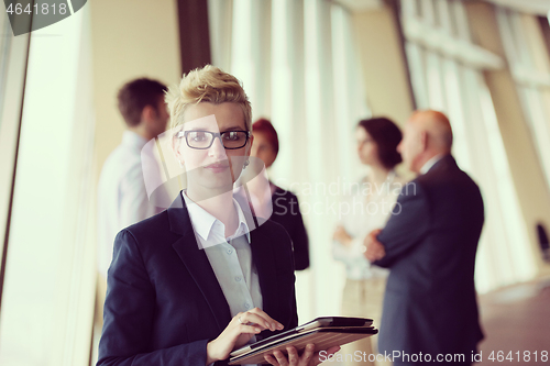 Image of portrait of older business woman  at office with tablet computer