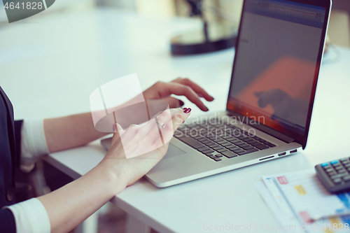 Image of business woman working on computer at office