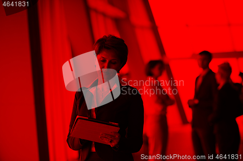 Image of business woman  at office with tablet  in front  as team leader