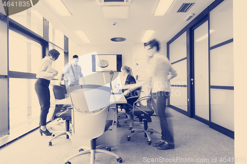 Image of business people group entering meeting room  motion blur