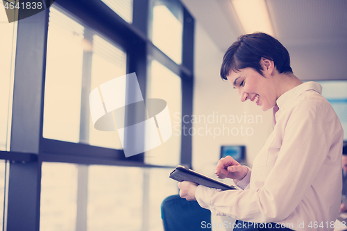 Image of business woman on meeting  using tablet