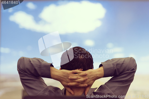 Image of young man dreaming clouds on presentation