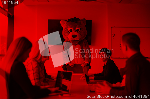 Image of boss dresed as bear having fun with business people in trendy of