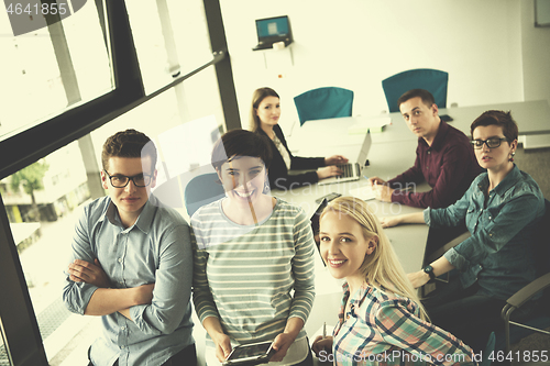 Image of group of Business People Working With Tablet in startup office