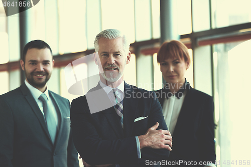 Image of senior business man with his team at office