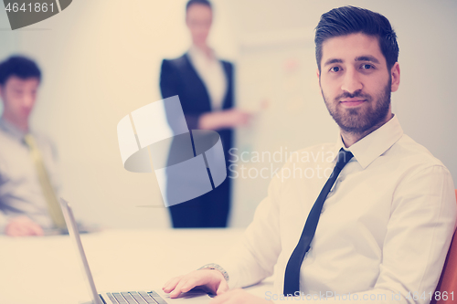 Image of young business man at meeting