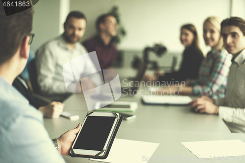 Image of Businessman using tablet in modern office