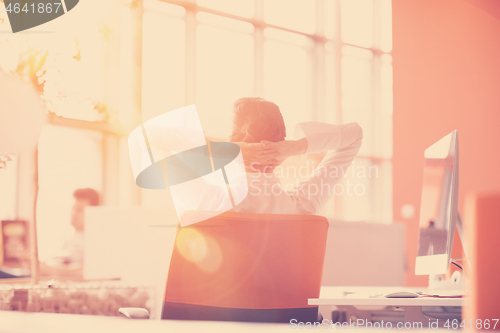 Image of young business woman relaxing at workplace