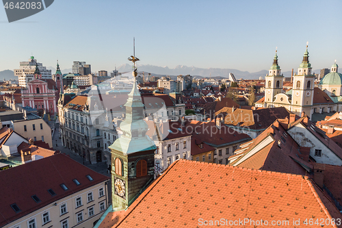 Image of Scenic panoramic aerial drone view of rooftops of medieval city center, town hall and cathedral church in Ljubljana, capital of Slovenia, at sunset