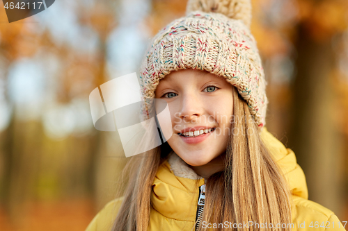 Image of portrait of happy girl at autumn park